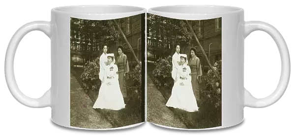 A western Red Cross female doctor(?) and two Japanese women posed in a garden, c1905. Creator: Underwood & Underwood. A western Red Cross female doctor(?) and two Japanese women posed in a garden, c1905. Creator: Underwood & Underwood
