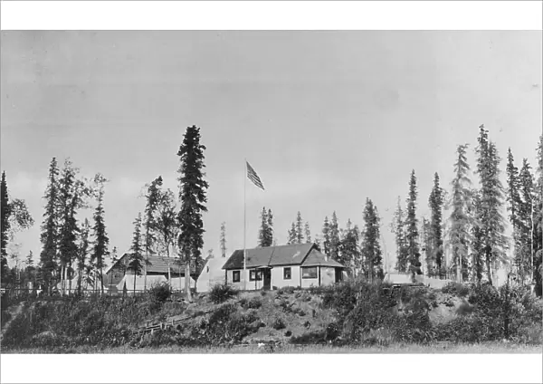 Building with American flag raised, between c1900 and 1916. Creator: Unknown