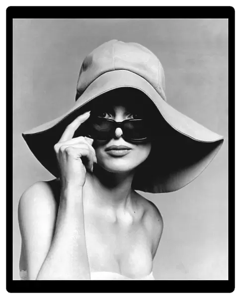 Model wearing floppy hat and sunglasses