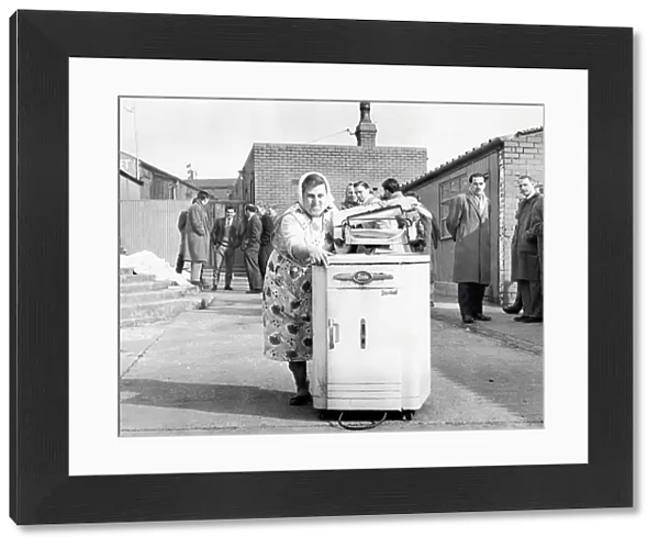 Mrs. Sarah Dewhirst taking away the washing machine from the Peel Park ground at Accrington Stanley, 1962