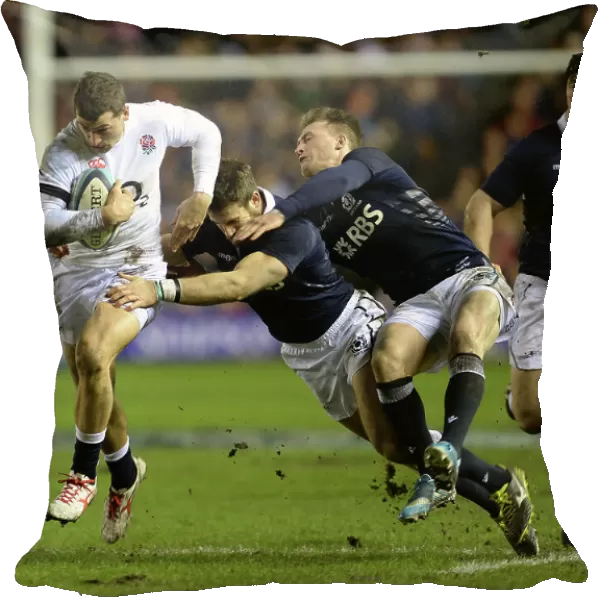 England's Jonny May runs with the ball as he evades a tackle