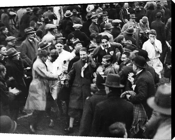 The crowd carry PT Murray to the pavillion after and Ireland win against England 1930