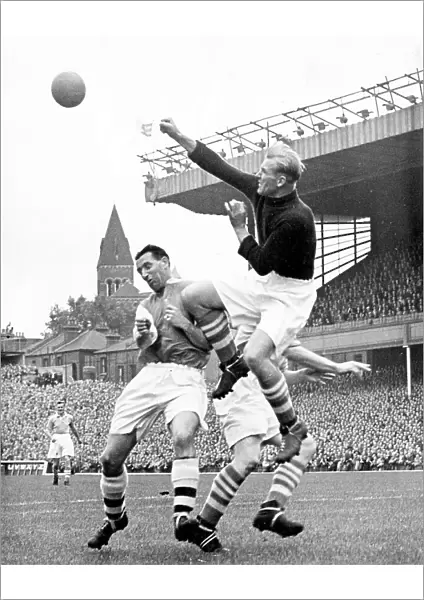 Bert Trautmann, Manchester City Goalkeeper clears the ball from Tommy Lawton of Arsenal