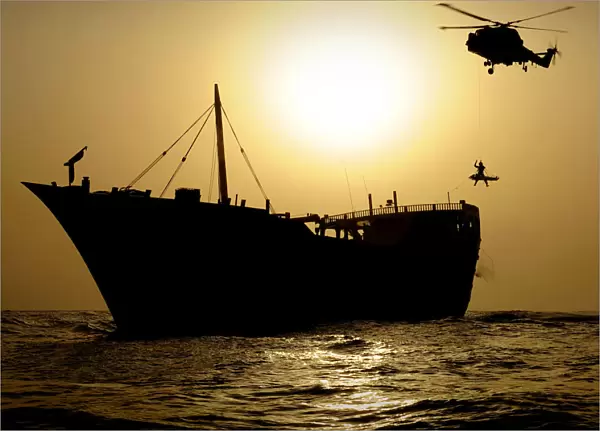 Royal Navy Helicopter Lowering Winchman onto Vessel in Gulf