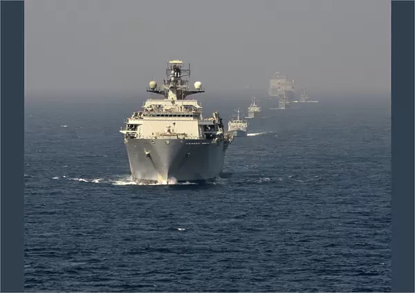 The Fleet Flagship of the Royal Navy, HMS Bulwark at sea with multinational vessels