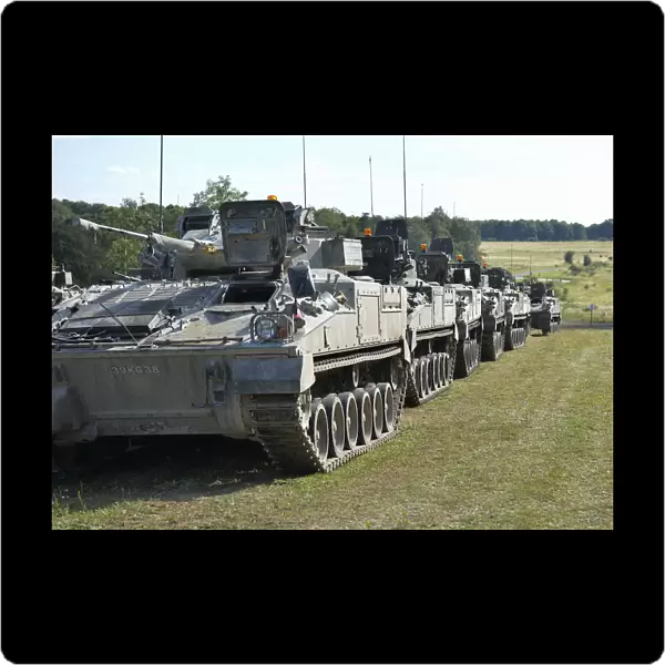 A line of Warrior vehicles wait for a call to action on Salisbury Plain during Exercise Lion Strike
