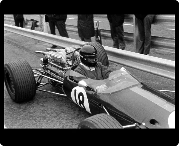 Formula One World Championship: Dan Gurney Brabham BT24 tests out a new Bell full-face crash helmet. He retired in the race with throttle slides