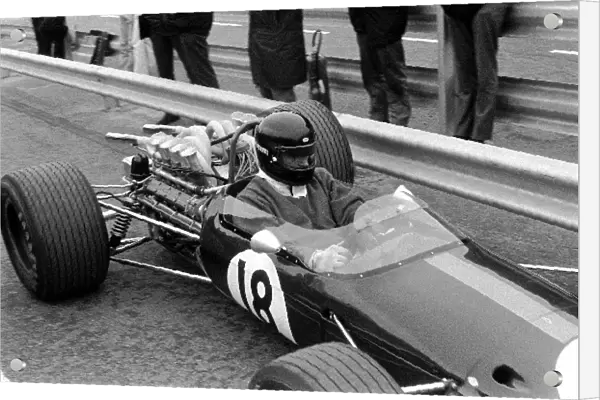 Formula One World Championship: Dan Gurney Brabham BT24 tests out a new Bell full-face crash helmet. He retired in the race with throttle slides