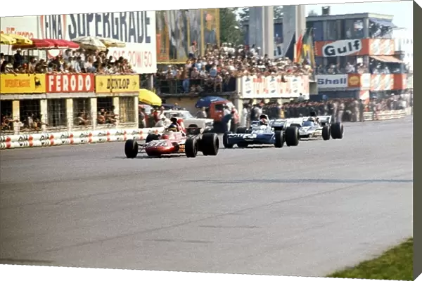 Formula One World Championship: Second placed Ronnie Peterson March 711 leads third placed Francois Cevert Tyrrell 002 and Mike Hailwood Surtees