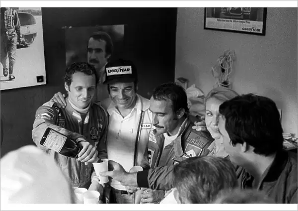 Formula One World Championship: New World Champion Niki Lauda celebrates with race winner and Ferrari team mate Clay Regazzoni in the Ferrari