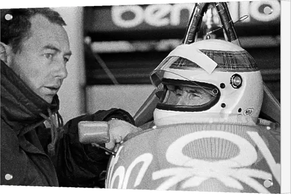 Formula One World Championship: Peter Collins Benetton Team Manager gives final instructions to Jackie Stewart before the former World Champion