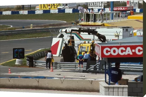 Formula One World Championship: The back end of Martin Donnellys wrecked Lotus is hauled away