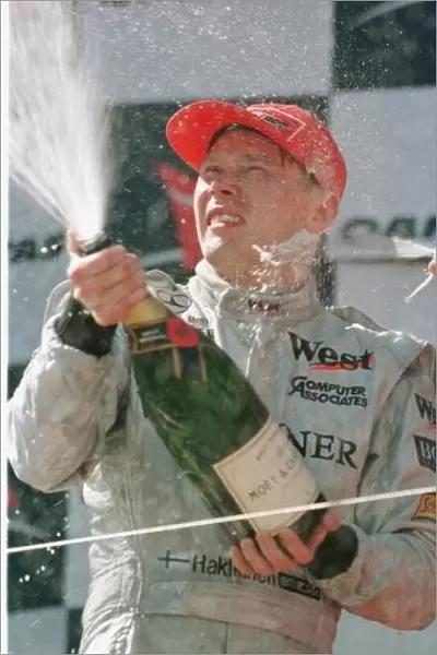SE 7. Mika Hakkinen celebrates his victory inthe Australian Grand Prix