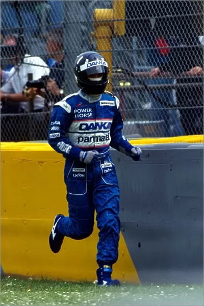 Formula One World Championship: Damon Hill, Arrows, makes his way to safety after a collision with the Prost of Shinji Nakano