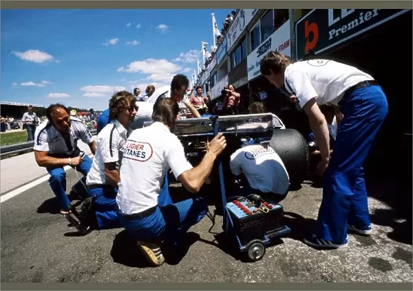 Formula One World Championship: The Ligier mechanics work on the rear of Jacques Laffites JS7 during practice