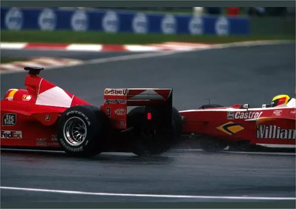 Formula One World Championship: Fourth place finisher Ralf Schumacher Williams FW21 makes a move on his brother Michael Schumacher Ferrari F399