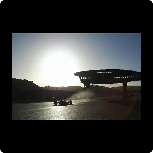 Formula One Testing: Mark Webber Jaguar Racing R3 passes the new viewing gantry at the Jerez circuit