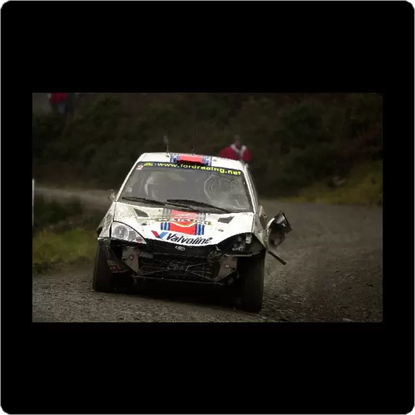 World Rally Championship: Carlos Sainz Ford Focus driving through Stage 11, Brechfa after an accident that injured fifteen spectators
