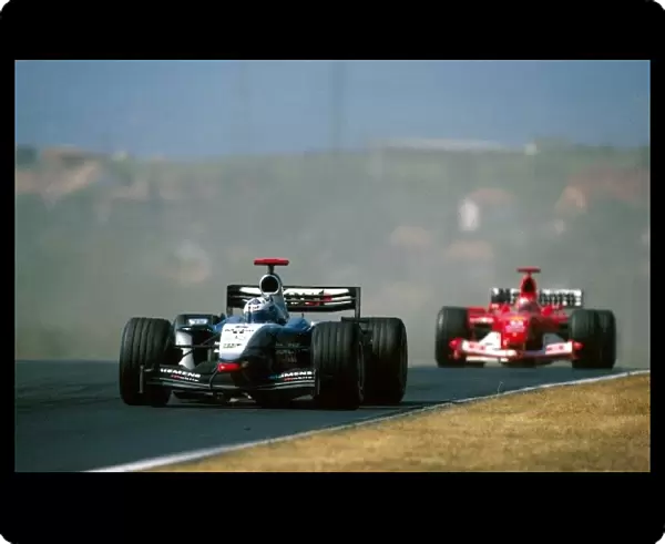 Formula One World Championship: Fifth placed David Coulthard McLaren Mercedes MP4  /  17D leads Michael Schumacher Ferrari F2003-GA, who finished eighth