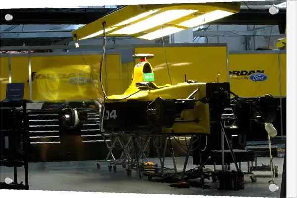 Formula One World Championship: Jordan mechanics work on the cars in the garage into the night