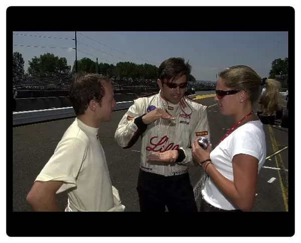 Christian Fittipaldi explains the fine art of going fast before qualifying for the G. I. Joes 200. Portland International Raceway, Portland, Or. 16 June, 2002