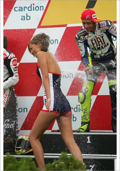 Valentino Rossi Fiat Yamaha Team sprays the podium girl with his champagne