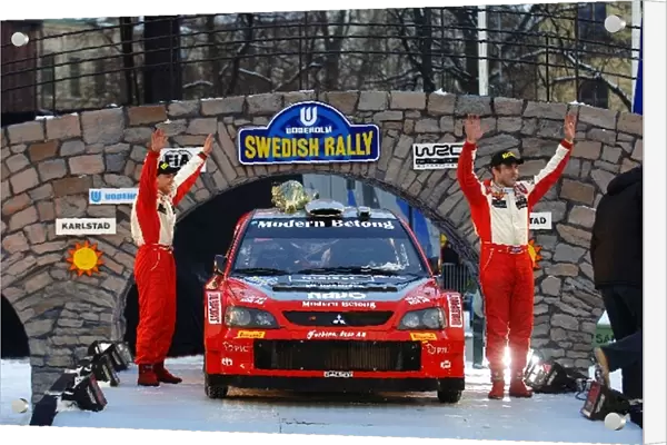 FIA World Rally Championship: Third placed Daniel Carlsson with co-driver Bo Holmstrand Mitsubishi Lancer WRC05 celebrates on the podium