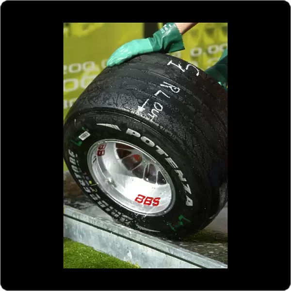 Formula One World Championship: A mechanic cleans a Bridgestone tyre