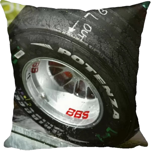 Formula One World Championship: A mechanic cleans a Bridgestone tyre