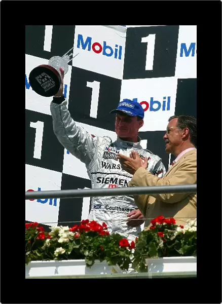 Formula One World Championship: Second placed David Coulthard McLaren celebrates on the podium