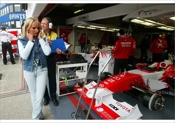 Formula One World Championship: Anne Panis, wife of Olivier Panis Toyota, shields her ears from the engine noise in the Toyota pit