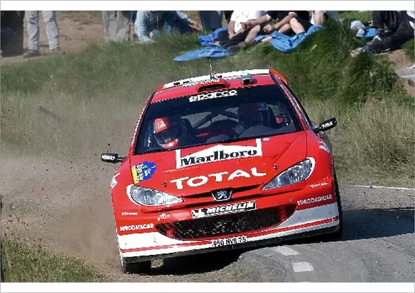 World Rally Championship: Richard Burns with co-driver Robert Reid Peugeot 206 WRC rides on the sumpshield as he cuts a corner on Stage 15