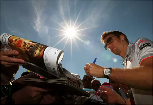 Formula One World Championship: Jenson Button McLaren signs autographs for the fans