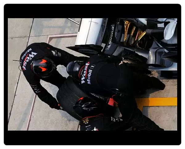 Formula One World Championship: McLaren pit crew change Kimi Raikkonen McLaren Mercedes MP4  /  20 blown tyre