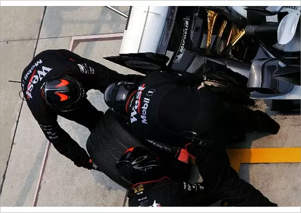 Formula One World Championship: McLaren pit crew change Kimi Raikkonen McLaren Mercedes MP4  /  20 blown tyre