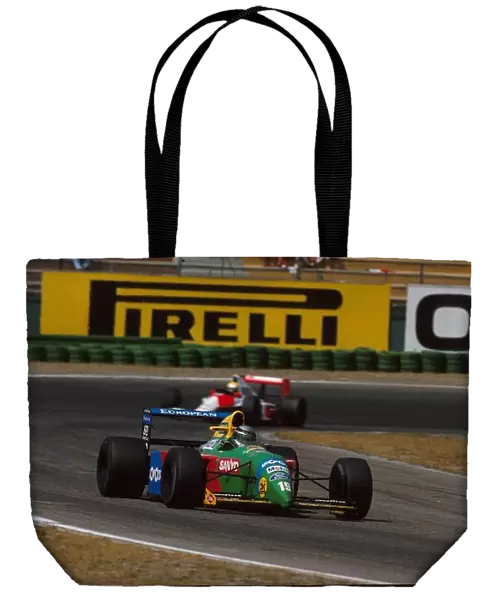 Formula One World Championship: The Benetton of Alessandro Nannini leads the Mclaren of race winner Ayrton Senna