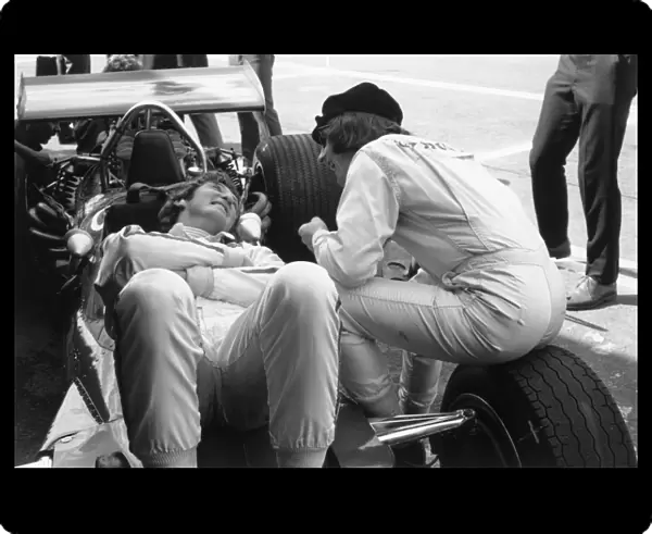 1969 Mexican Grand Prix: Jackie Stewart shares a joke with Jochen Rindt during practice, portrait