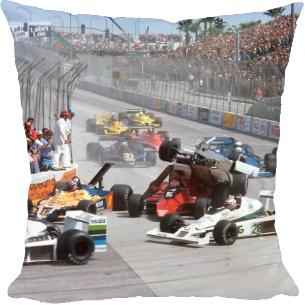 Long Beach, California, USA: Patrick Tambay flies over the back of Niki Laudas at the Hairpin on lap 1