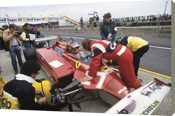 1981 British Grand Prix: Gilles Villeneuve, retired, in conversation with teammate Didier Pironi, in the pits, portrait