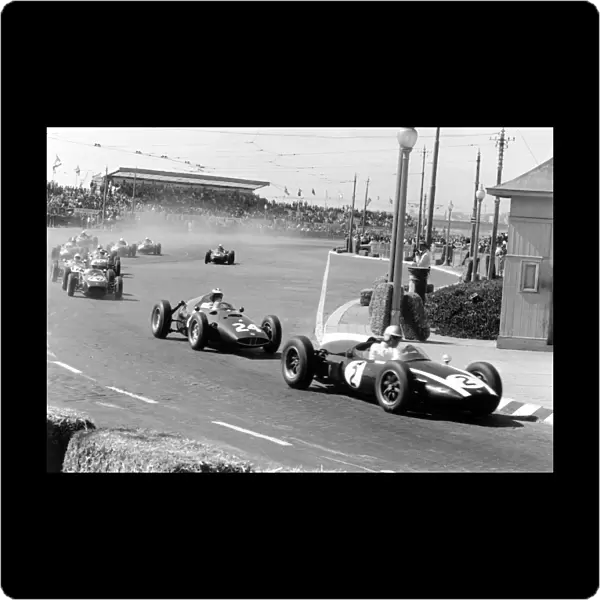 1960 Portuguese Grand Prix: Jack Brabham, Cooper T53-Climax, 1st position, leads Dan Gurney, BRM P48, retired, John Surtees, Lotus 18-Climax