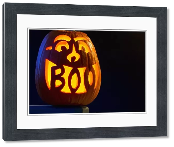 Carved Pumpkin Glowing With The Word Boo Carved In Mouth; Calgary, Alberta, Canada