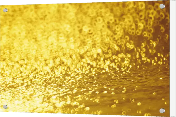 Closeup Of Golden Shimmering Reflections Off Water