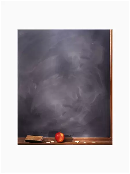 Apple On Ledge Of Blackboard