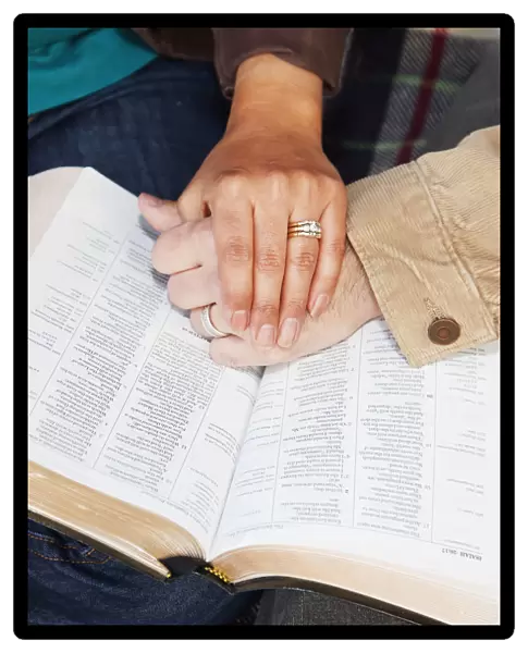 Couples hands on top of a bible; Edmonton alberta canada