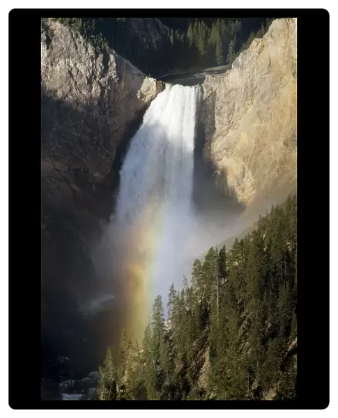 Waterfall Over Cliff Creating A Rainbow