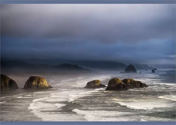 Sunlight And Mist Create Coastal Moods; Cannon Beach, Oregon, United States Of America