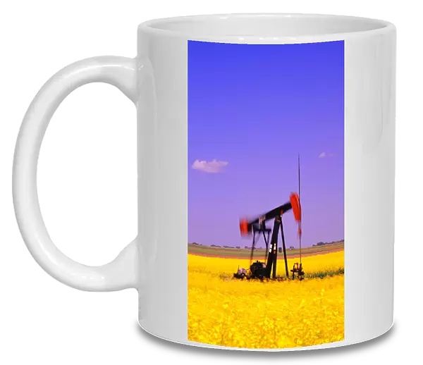 Oil Pumpjack In A Canola Field