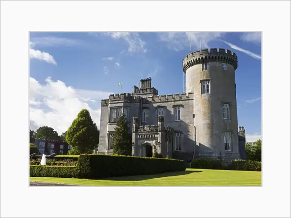 Stone Castle With Turret, Manicured Grass, Gardens, Fountain, Blue Sky And Clouds; County Clare, Ireland