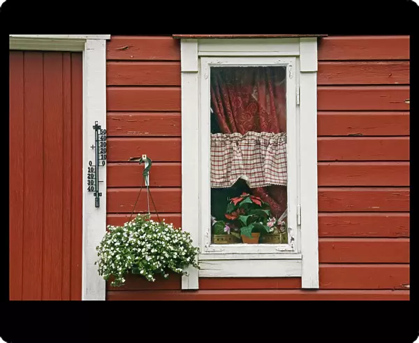 Red Wooden House With Plants In And By Window, Close Up