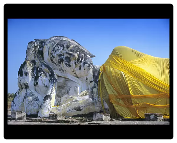 Reclining Budda statue wrapped with yellow cloth